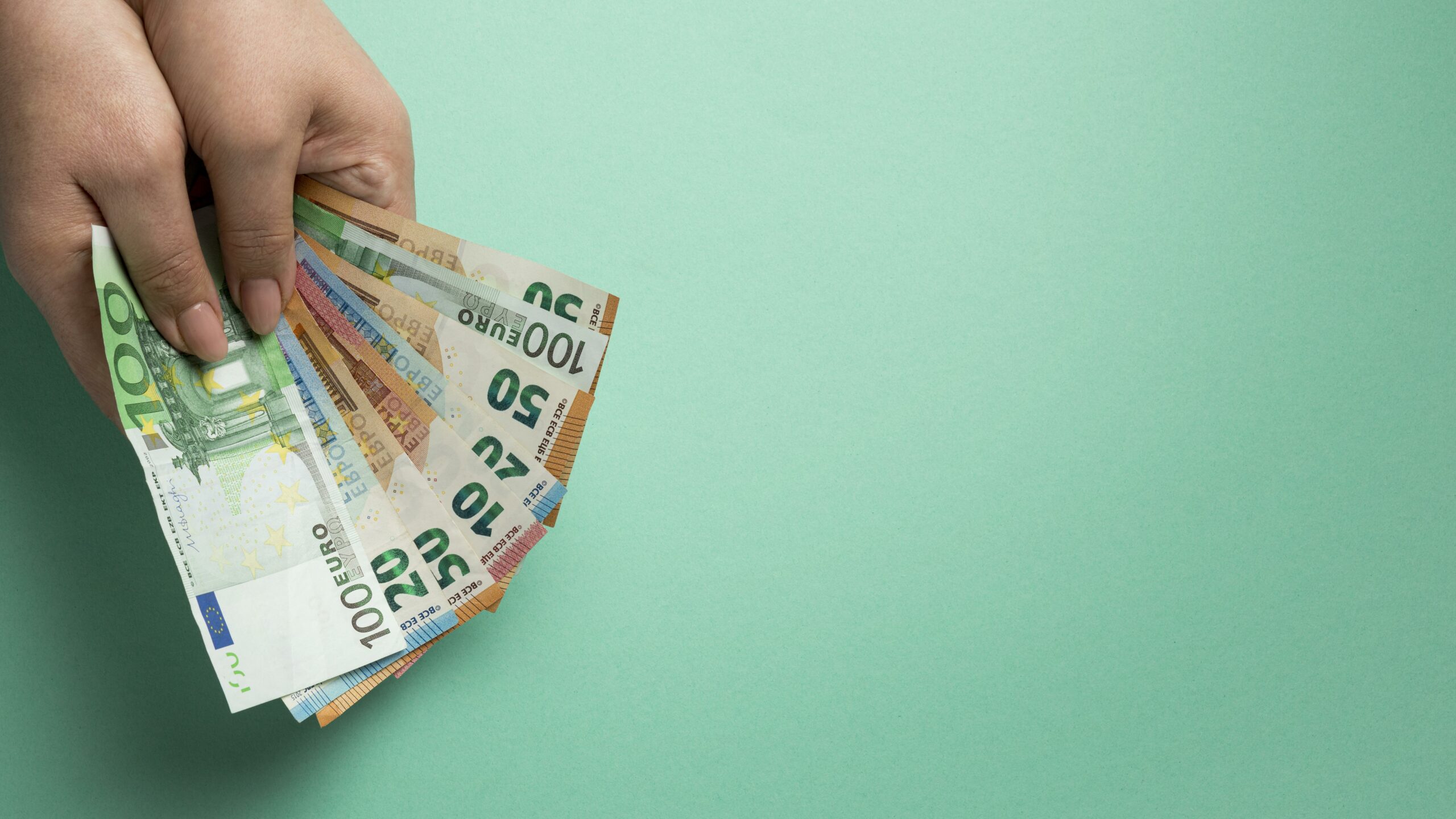 person-holding-banknotes-with-copy-space